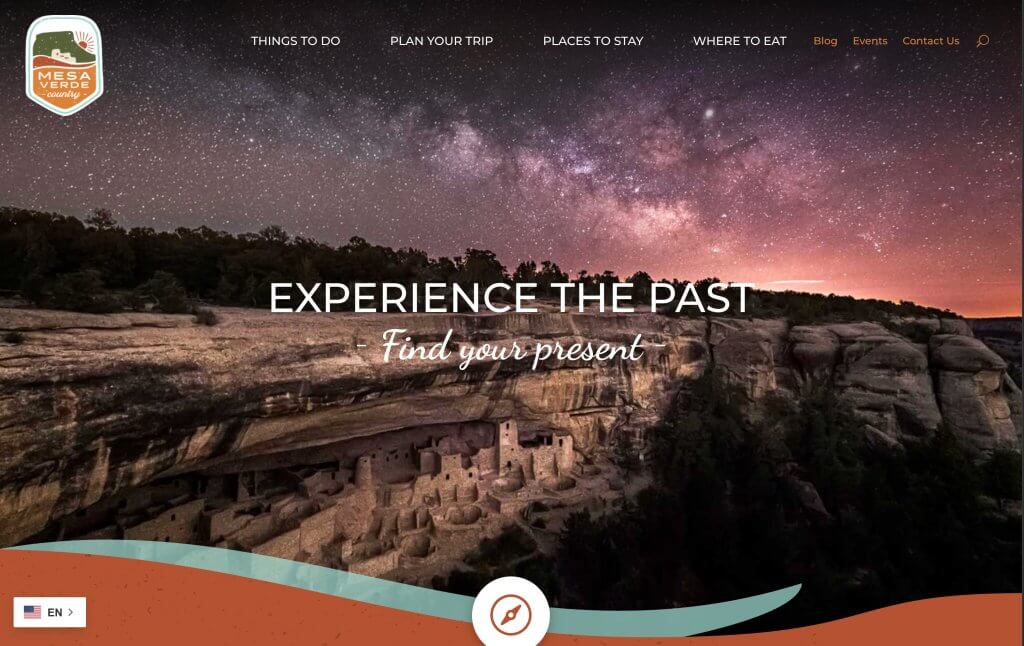 Mesa Verde County tourism website banner showing cliff dwellings under a star-filled night sky