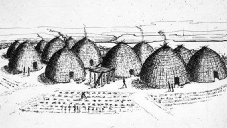 Black-and-white drawing of a historic Indigenous village with rows of dome-shaped grass huts and cultivated fields.